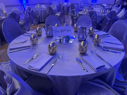 Table set with silver linens and gold "dragon" eggs