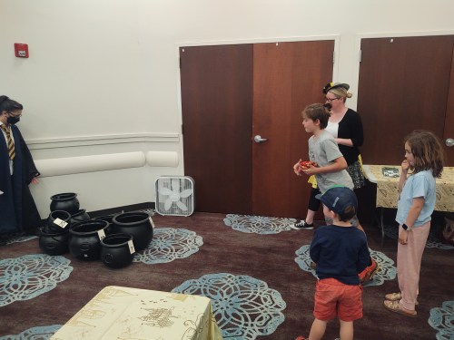 kids playing beanbag toss with cauldrons