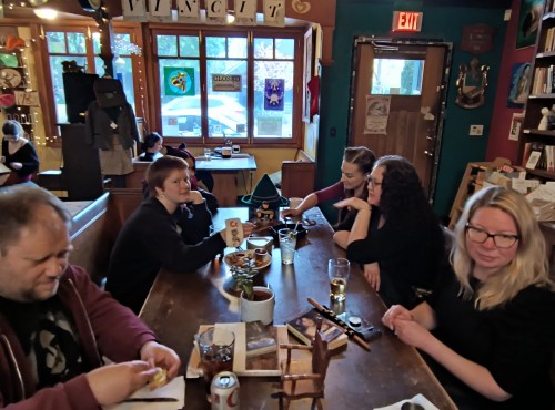 6 people around a table playing a game