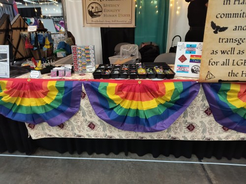 SPEWW booth with a selection of buttons